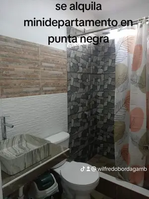 a bathroom with a toilet and a shower curtain at Hospedaje Ocean Glips in Punta Negra