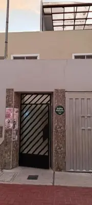 a building with a garage door on the side of it at Casa del Olivar Pisco in Pisco