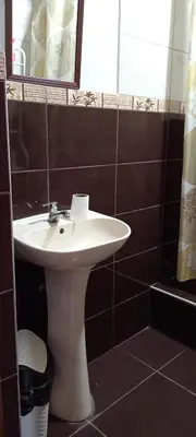 a bathroom with a white sink and a mirror at Casa del Olivar Pisco in Pisco