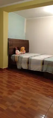 two stuffed animals sitting on a bed in a room at Casa del Olivar Pisco in Pisco