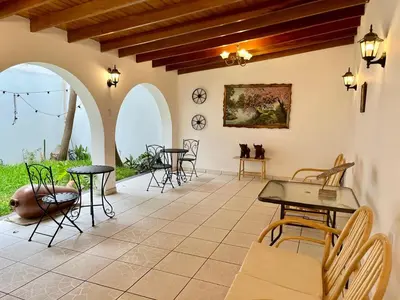 a patio with tables and chairs in a building at Casa Cerezos in Ica