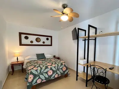 a bedroom with a bed and a ceiling fan at Casa Cerezos in Ica