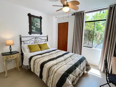 a bedroom with a bed and a window at Casa Cerezos in Ica