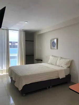 a bedroom with a large bed with a large window at Hotel Inkayacu Paracas Café in Paracas