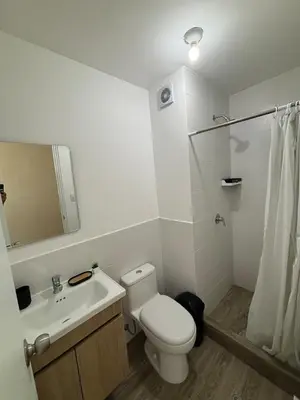 a bathroom with a toilet and a sink and a shower at Modern apartment in Lima Surquillo in Lima