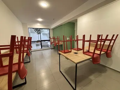 a dining room with red chairs and a table at Modern apartment in Lima Surquillo in Lima