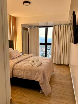 a bedroom with a bed and a large window at seipoz in Lima