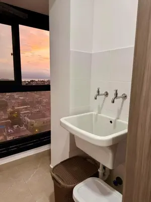 a bathroom with a sink and a toilet and a window at seipoz in Lima