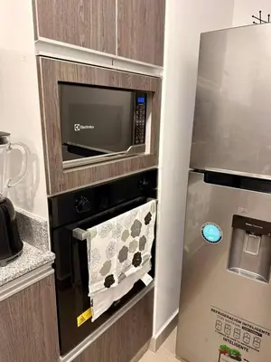 a kitchen with a microwave oven with a towel at seipoz in Lima