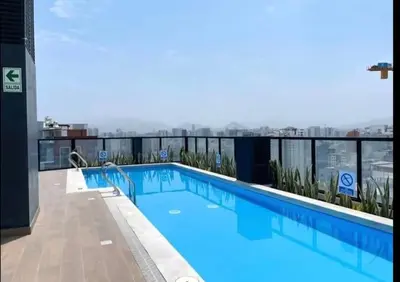 a swimming pool on the roof of a building at Cozy apartment, downtown area, fully equipped in Lima
