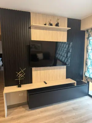 a living room with a desk with a tv at Confortable y moderno apartamento en Lima, cerca al centro de Lima, MIraflores y San IsidroN ISIDRO in Lima