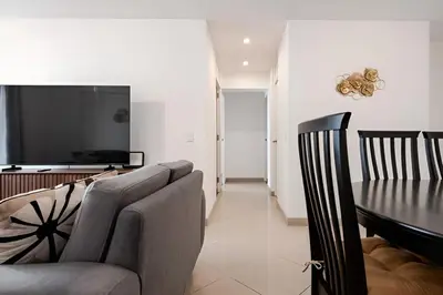 a living room with a couch and a dining table at Bajada Balta Suites Spacious 3BR in Miraflores Walkable Area in Lima