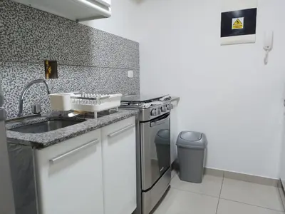 a kitchen with a sink and a stove at Cozy Central Apartment Ideal for Work & Travel in Lima