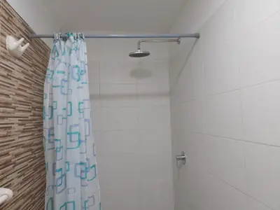 a shower with a shower curtain in a bathroom at Cozy Central Apartment Ideal for Work & Travel in Lima