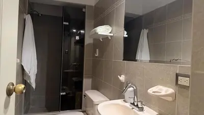 a bathroom with a toilet and a sink and a shower at A2 cuadras de Larcomar - Miraflores in Lima
