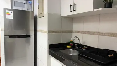 a kitchen with a sink and a refrigerator at A2 cuadras de Larcomar - Miraflores in Lima