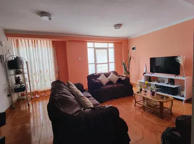 a living room with a couch and a tv at Wasin Kusi in Ayacucho