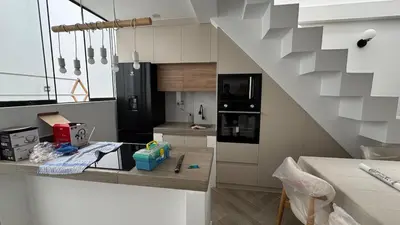 a kitchen with white cabinets and a black refrigerator at Casa de estreno en Playa Los Lobos - Cerro Azul in Cerro Azul