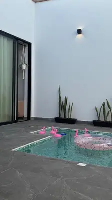 a swimming pool with pink flamingos in the water at Casa de estreno en Playa Los Lobos - Cerro Azul in Cerro Azul
