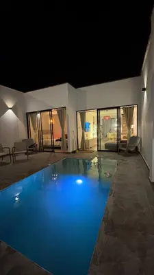 a large swimming pool with blue water in a house at Casa de estreno en Playa Los Lobos - Cerro Azul in Cerro Azul