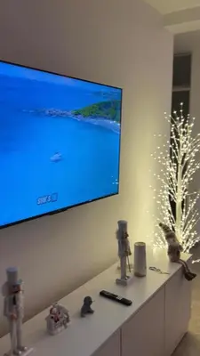 a living room with a large flat screen tv on a wall at Casa de estreno en Playa Los Lobos - Cerro Azul in Cerro Azul