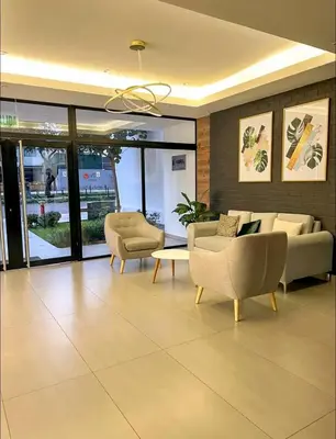a living room with two couches and a table at Modern room by the sea in Lima