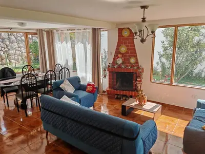 a living room with blue couches and a fireplace at UMAY lodge house in Urubamba