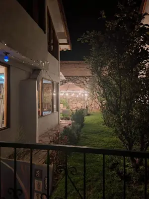 a house with a fence and a yard at night at UMAY lodge house in Urubamba