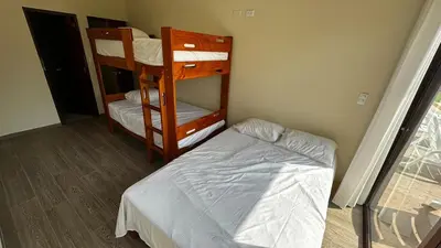 a bedroom with two bunk beds and a bed at Welcome to our Pachacamac retreat in Pachacamac