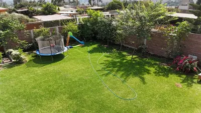 an aerial view of a backyard with a water hose at Welcome to our Pachacamac retreat in Pachacamac