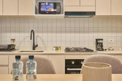 two water bottles sitting on a table in a kitchen at Saturn by Geko in Lima