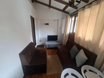 an overhead view of a living room with a couch and a laptop at Acogedor Departamento Vitoque in Cusco