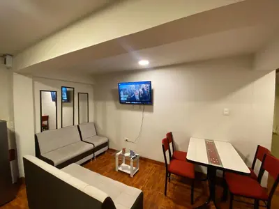 a living room with a couch and a table at Cozy aparts & rooms in Cusco