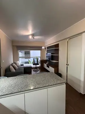 a kitchen and living room with a couch at Moderno Departamento en Lima - Chorrillos in Lima
