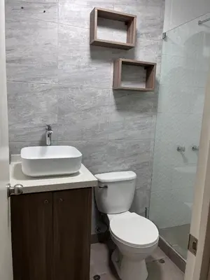 a bathroom with a toilet and a sink and a shower at Moderno Departamento en Lima - Chorrillos in Lima