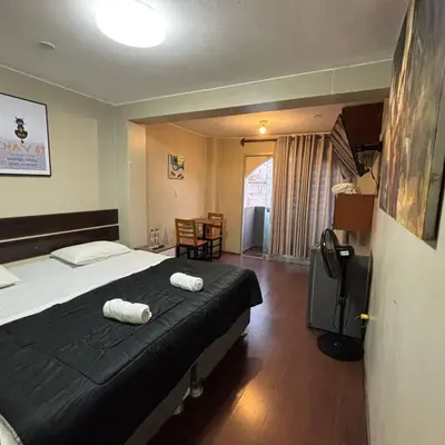 a bedroom with a bed with two towels on it at Miraflores Thay Colonial in Lima