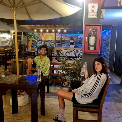 a man and woman sitting at a table in a restaurant at Miraflores Thay Colonial in Lima