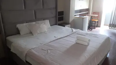 a bedroom with a large white bed with two pillows at Miraflores Thay Colonial in Lima