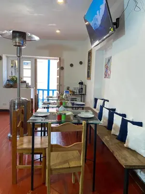 a dining room with a table and a couch at Runa House2 in Cusco