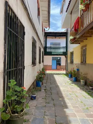 an alley with potted plants on the side of a building at Runa House2 in Cusco