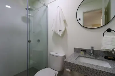 a bathroom with a shower and a toilet and a sink at Stunning 2BR with Balcony & City Views in Lima