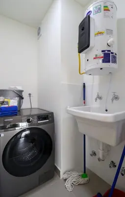 a bathroom with a washing machine and a sink at Stunning 2BR with Balcony & City Views in Lima