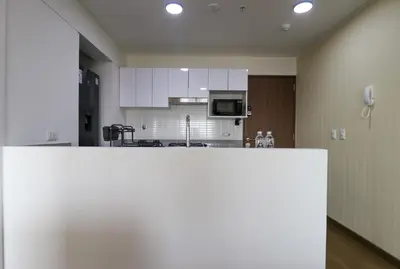 a kitchen with white cabinets and a refrigerator at Stunning 2BR with Balcony & City Views in Lima