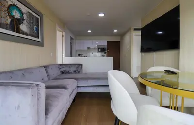 a living room with a couch and a glass table at Stunning 2BR with Balcony & City Views in Lima