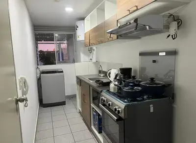 a kitchen with a stove with pots and pans on it at Departamento cómodo a 20 minutos del aeropuerto in Lima