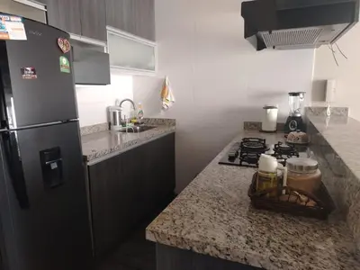 a kitchen with a refrigerator and a counter top at Departamento Surquillo INEN in Lima