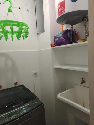 a kitchen with a green chandelier above a sink at Departamento Surquillo INEN in Lima