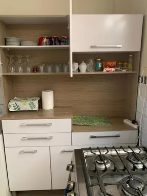 a kitchen with white cabinets and a stove top at Apartamento cerca a lugares turísticos en Ica para 5 personas in Ica