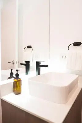 a bathroom with a white sink and a mirror at 1BDR Modern apartment in Barranco in Lima