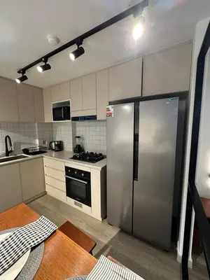 a kitchen with a stainless steel refrigerator in it at 1BDR Modern apartment in Barranco in Lima